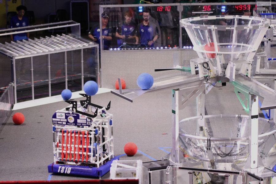 Launching the blue ball up into the basket, the robotics team competes Saturday, March 26 at Lee’s Summit North where the team placed 14th. 