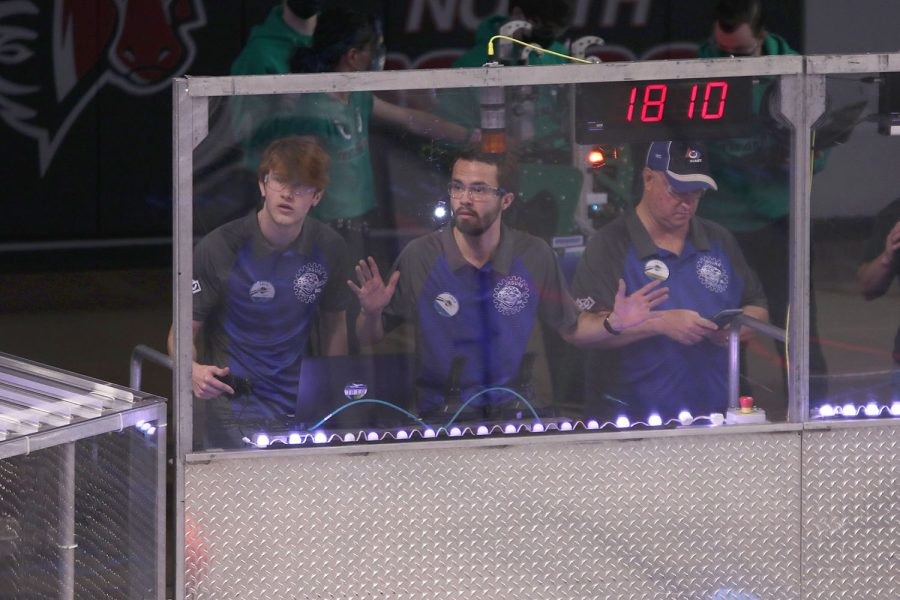 As they stare at the scoreboard, seniors Darren Hall and Ryan Layton wait with anticipation for the final results of the match. 
