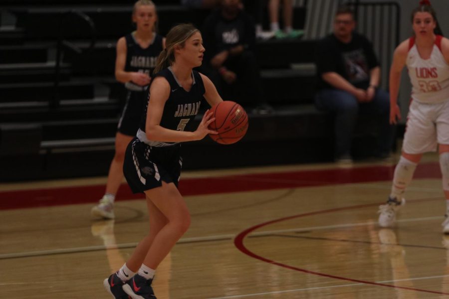 With the ball in her hand, senior Mackinley Fields prepares to pass the ball to her teammate.