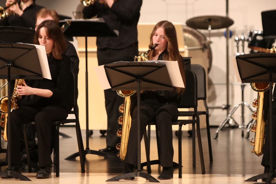 Saxophone player, sophomore Michelle Marney, focuses on the music sheet while playing.