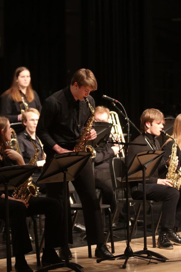 Above his chair, junior Brody Shulda stands up while playing his solo. 