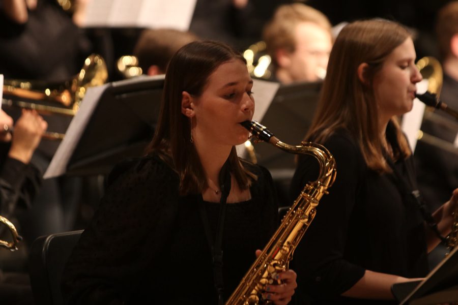 Looking down at her music, senior Abby Hayes focuses on her music sheet while playing. 