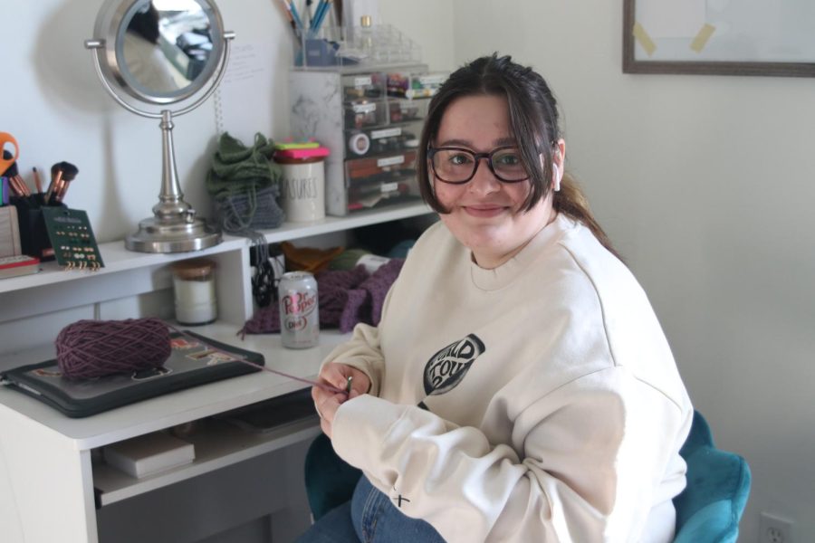 Relaxing at her desk, sophomore Ella Edwards starts another patch for her cardigan Sunday, Feb 27.