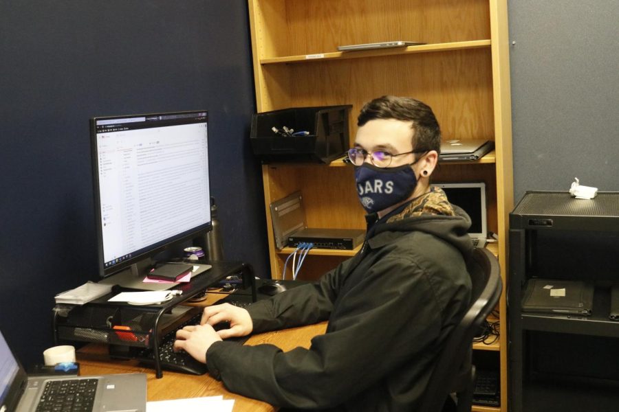 School technician, Garrison Ballam who is a technician who usually checks the computer in for new students, helps someone and fix the issues on their computer Thursday, Feb. 24.