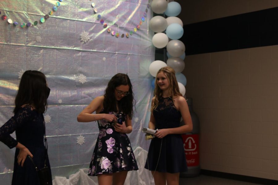 As three friends gather in a group, freshmen Sophie Hsu, Halle Nelson, and Marissa Akehurst prepare for the dance. 