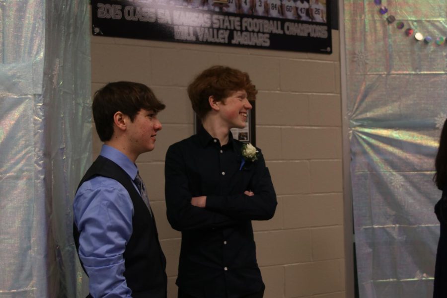 Smiling at their friends, freshmen Joseph Bolella and Brayden Evans talk before entering the dance.