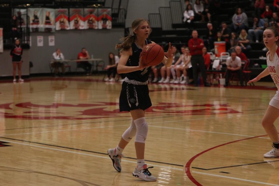 Passing the ball, freshman Averie Landon looks for an open teammate.