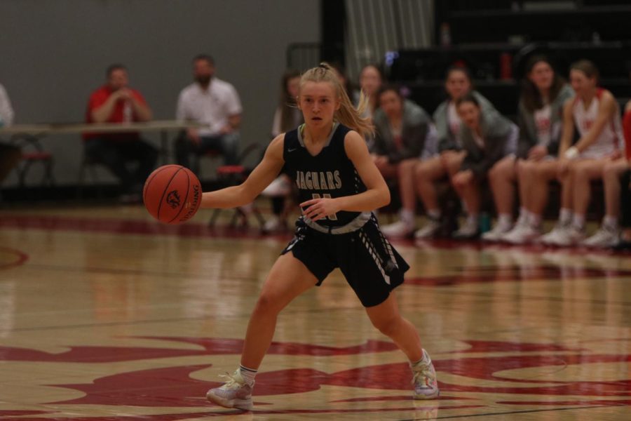 Dribbling down the court, junior Sophie Pringle goes to the basket Saturday, March 5 at Lansing High School.