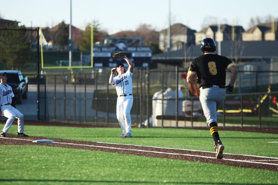 Securing a fly ball, junior Trent Gietzen takes the final out of the inning.