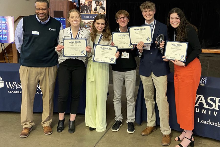 After being announced the Washburn Leadership Challenge Event champions, seniors Damara Stevens, Lauren Payne, junior Sonny Pentola, and seniors Bret Weber and Sydney Wootton pose for a picture with their award and certificates Friday, March 4.