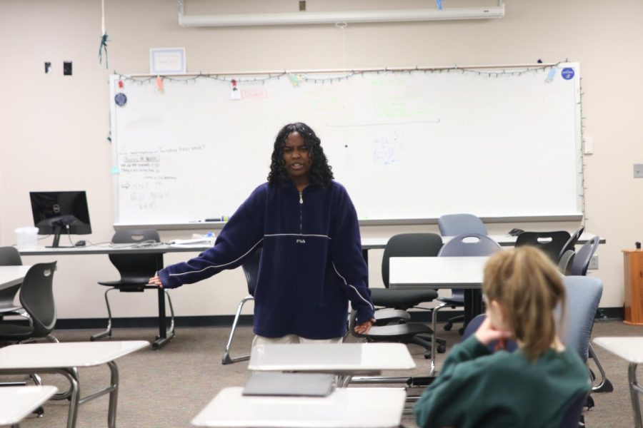 In Forensics class on Friday, February 25 senior Megan Habib is presenting her skit about characters in a book store in front of her class