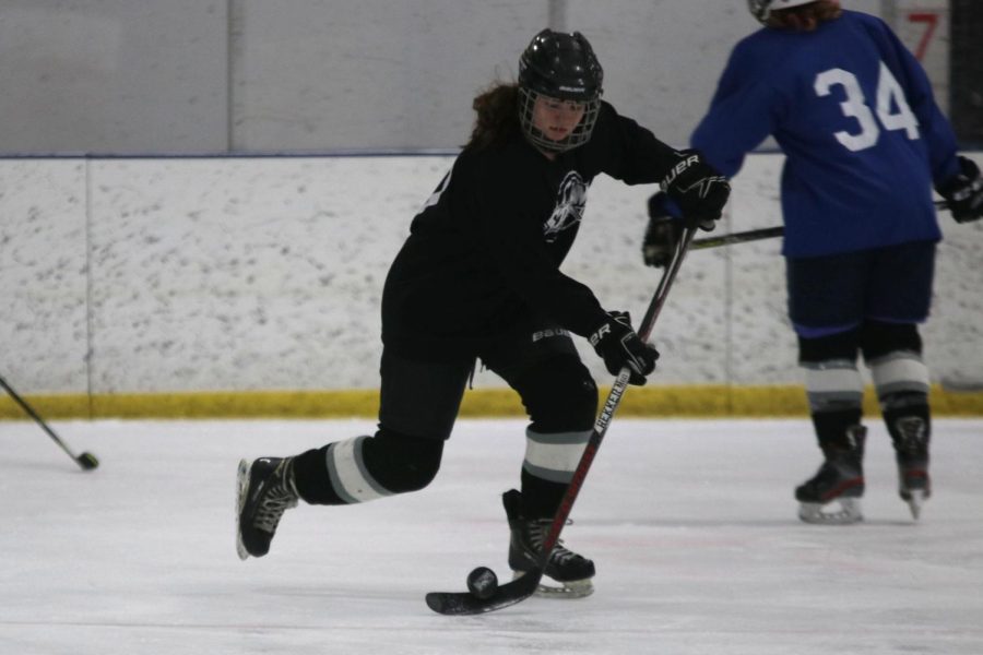 Eyes on the puck, freshman Kaitlyn Fitzpatrick participates in a drill at hockey practice with her co-ed team Thursday, Feb. 10. Fitzpatrick plays for the KC Stars.
