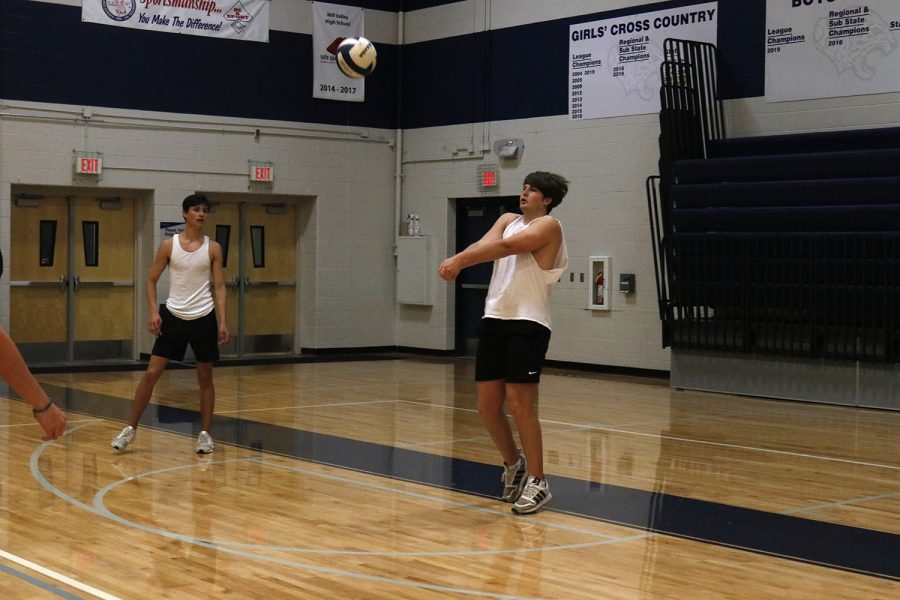 Senior Evan Harris prepares to hit the ball back over to the other team.