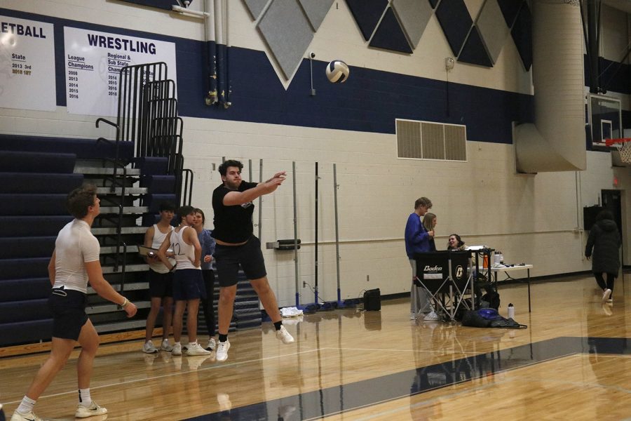 Senior Ryan Fulcher sets the ball from the back of the court.