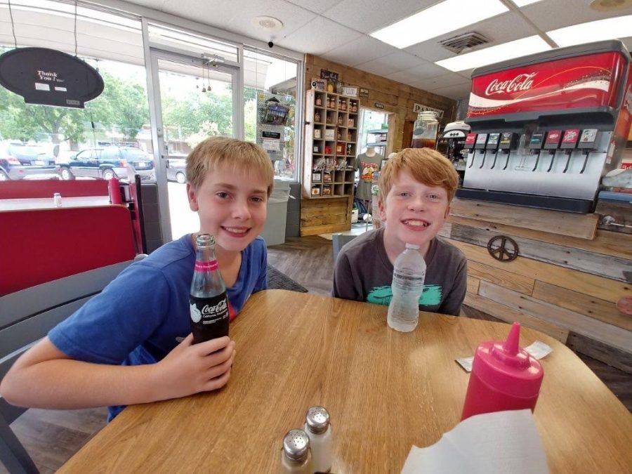 Holding their drinks at a local restaurant, freshmen Zach Chesser and Brayden Evans sit by each other. Having been friends since the two were put in the same second grade class,  Chesser and Evans take pride in their closeness with one another that still holds strong seven years later, Were the really stereotypical, close friends, Evans said.