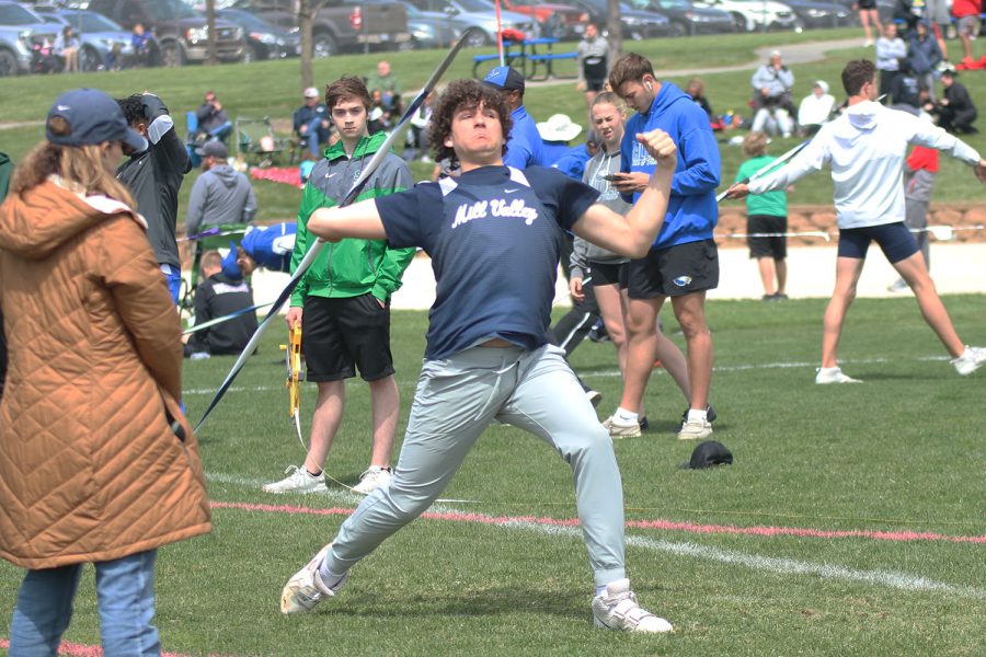 With his arm stretched behind him, freshman Abram Shaffer steps to throw the javelin. 