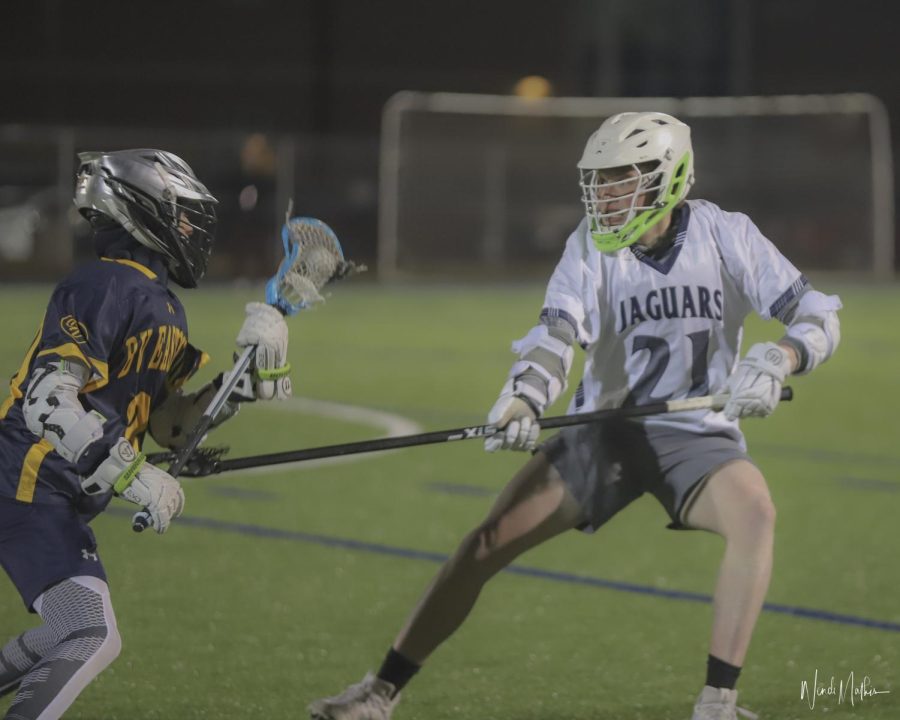 Senior Jack Bowden challenges an opponent and tries to steal the ball.