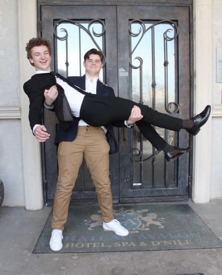 Posing for a Winter Homecoming photo, junior Atticus OBrien holds junior Finn Campbell in his arms. Campbell and OBrien have been friends for almost nine years, their friendship starting when Campbell began attending Horizon Elementary School when the two were in third grade.