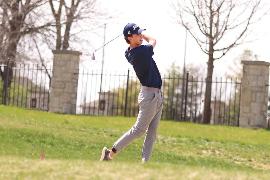 Following through with his swing, senior Jack Weber keeps his eyes on the ball while its up in the air. Weber ended up with a final score of 83 at Falcon Lakes Golf Club Invitational Monday, April 11.

