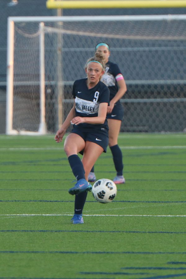 Eyes on a teammate, sophomore Julia Coacher passes the ball.