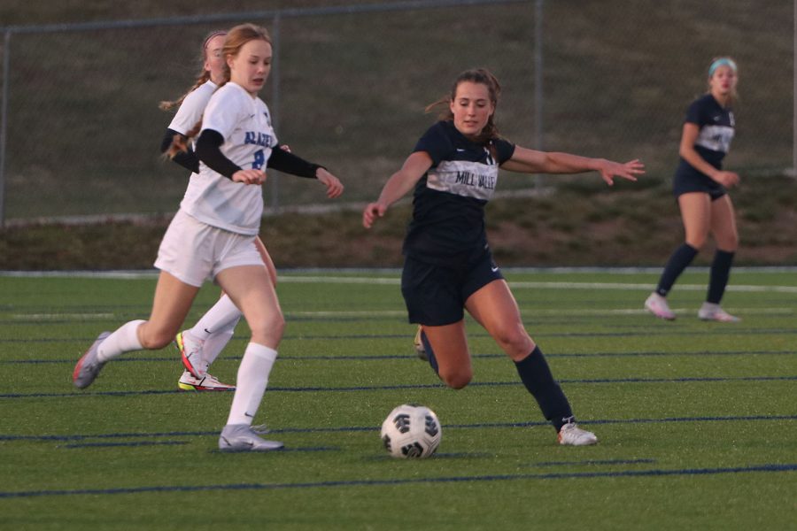 Blocking out her opponent, junior Laney Reishus attempts to gain possession of the ball.