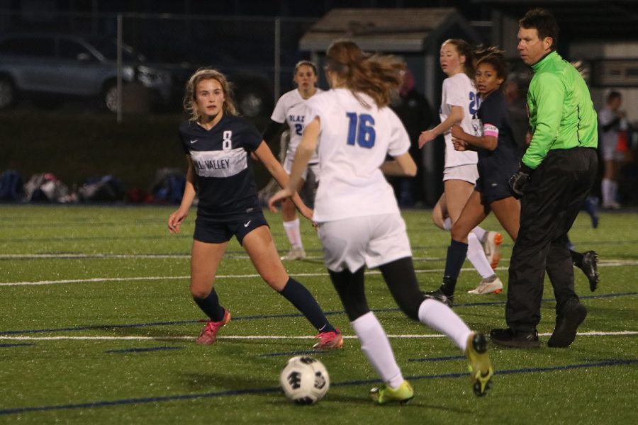 As an opponent comes near her, sophomore Kate Ricker moves to defend the ball.