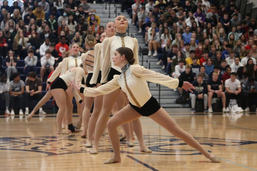 At the front of the line of other silver stars members, sophomore Keira Bret leans out to the side.