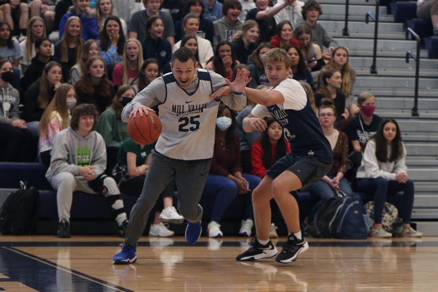 Near the edge of the court, girls basketball head coach Adam Runyan breaks through senior Jackson Van Dyke’s defense.