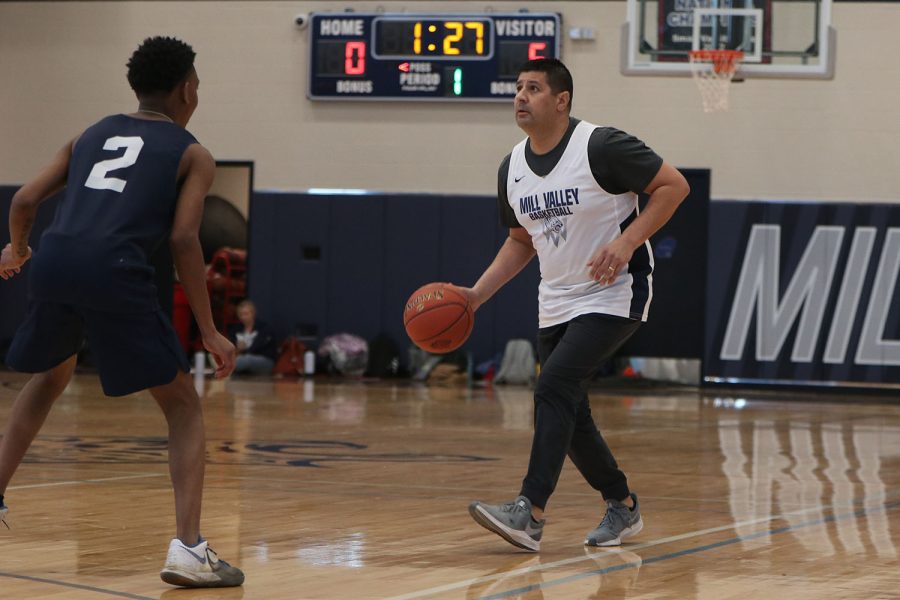 Eyes on the basketball net, boys wrestling head coach Travis Keal plans his next move.