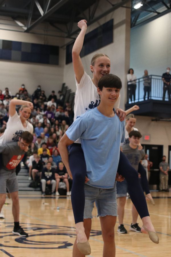 During the silver studs performance, senior Brock Olson holds senior Hadley Skinner on his back.