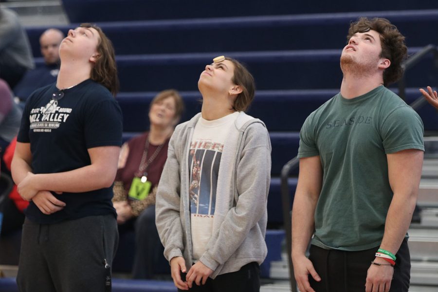 In the beginning of the prom candidate game, seniors Laird Toland, Lauren Payne and John Teska try to get their Oreo from their forehead to their mouth.