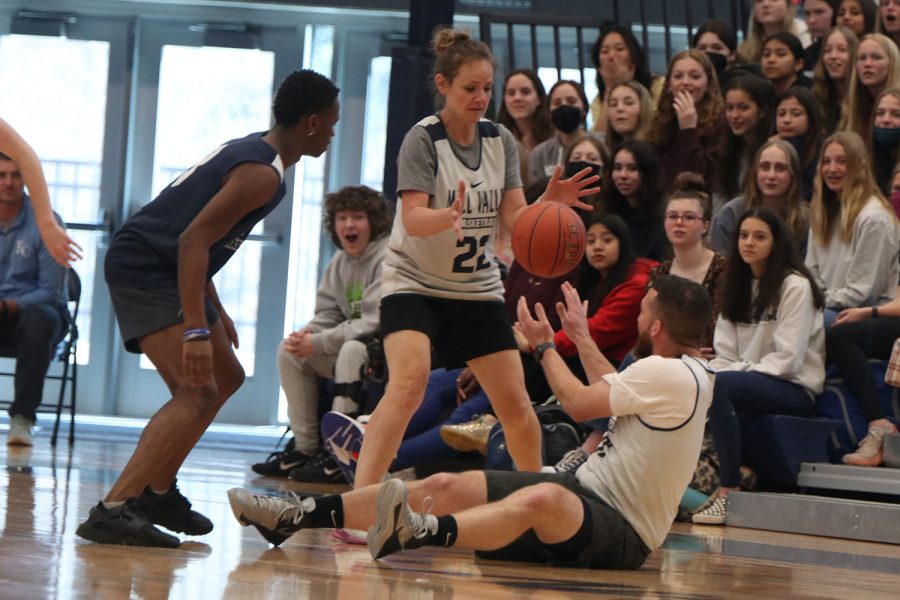 On the ground, athletic director Brent Bechard passes the ball to choir teacher Jessie Reimer.