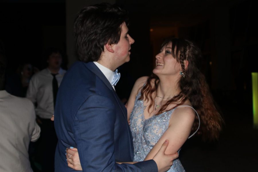 On the dance floor with her date, junior Maddie Hanna laughs while dancing. 