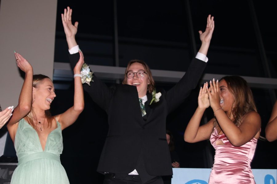 Celebrating his win for prom king, senior Laird Toland throws his hands in the air.