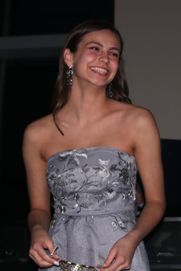 Looking toward the crowd in front of her, senior Lauren Payne smiles after hearing her name announced for prom queen.