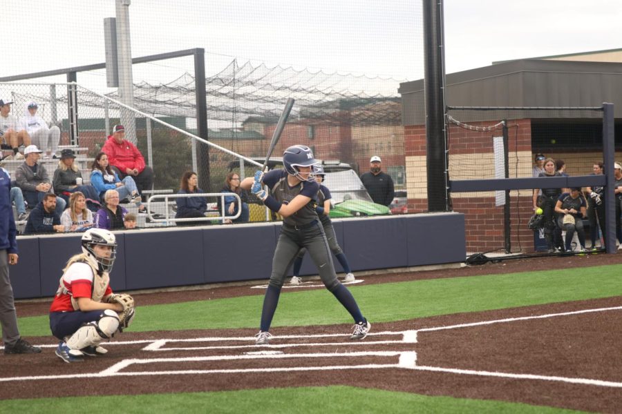 Holding the bat, sophomore Brooklyn LaFron prepares to hit the incoming ball.