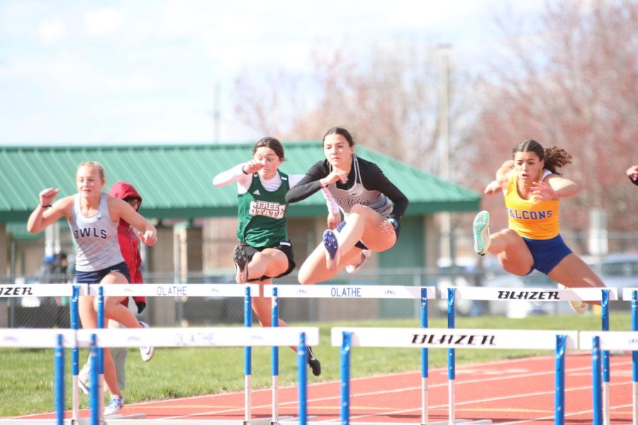 Arms out, senior Quincy Hubert clears the first hurdle with ease. Hubert set her first record of the season in the 100 meter hurdles, finishing in first place with a record-breaking time of 15.09 seconds.