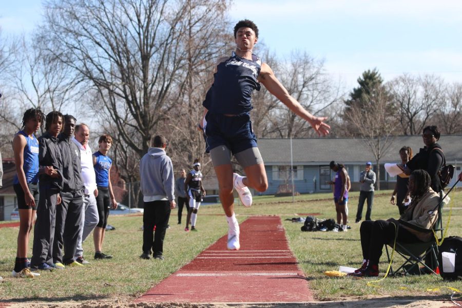 Competing in the triple jump, senior Adrian Dimond looks down to see where he will land. Dimond took first in triple jump with a distance of 42-11.00.
