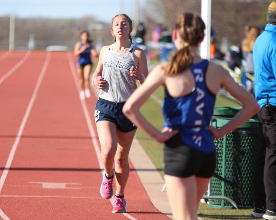 Crossing the finish line at last, sophomore Sarah Anderson exhales as she finishes the 1600 meter run.