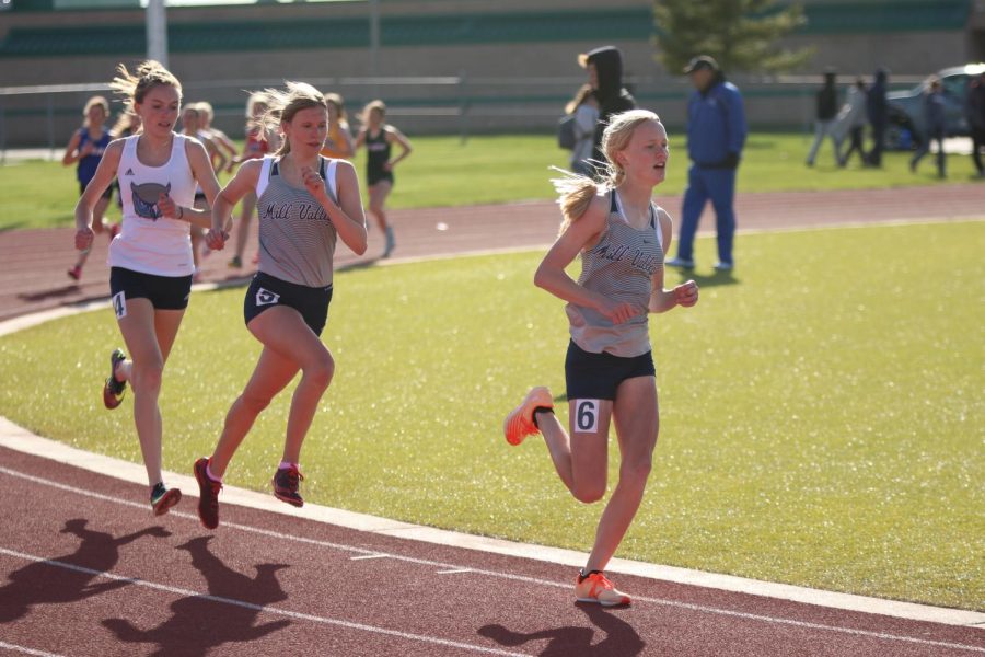 Leading the pack of runners, senior Katie Schwartzkopf follows close behind freshman Charlotte Caldwell during the third lap of the 1600 meter run. Schwartzkopf and Caldwell placed third and second respectively.