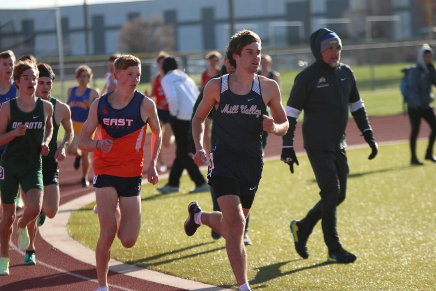 Senior Chase Schieber leads the front pack of runners of during the first lap of the 1600 meter race. Schieber placed third with a mile time of 4:32.