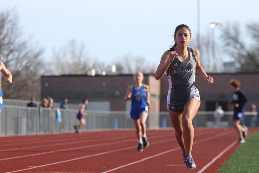Coming up on the tracks curve, freshman Isabel Cherrito runs the 400-meter dash.