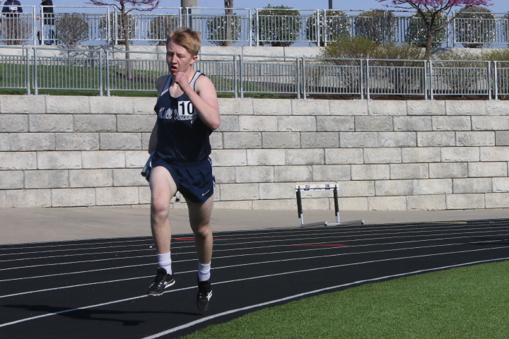 Eyes up, junior Dylan Miller strides out toward the finish line in the 400-meter dash.