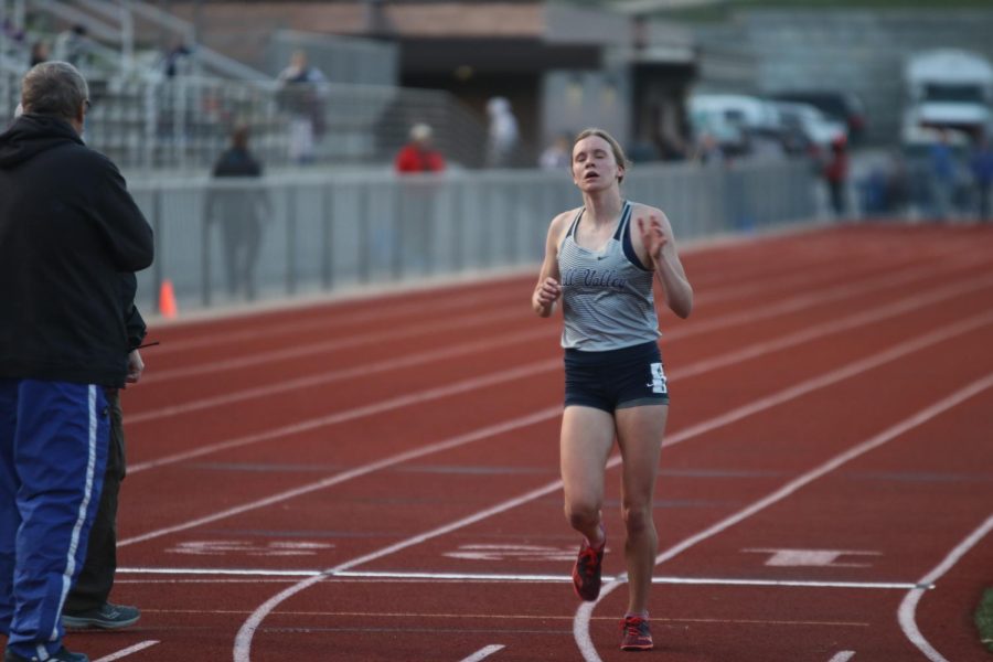 Exhaling, senior Katie Schwartzkopf is the first to finish the 3200-meter run. Schwartzkopfs final time of 11:32 was 20 seconds ahead of Grain Valley runner up Ella Casey.