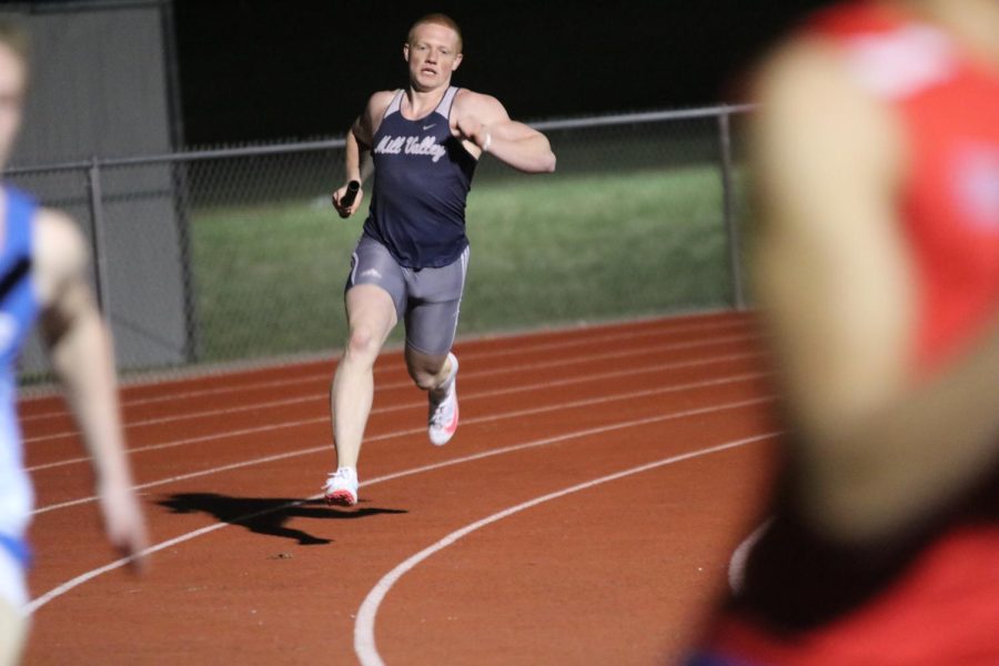 Rounding the track, senior Jared Napoli runs his leg of the 4x400-meter relay.