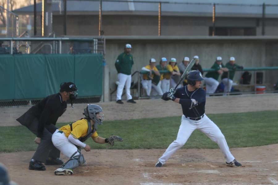 Up to bat, sophomore Blake Neis concentrates on the ball when playing Shawnee Mission South.The team came out on top with a final score of 12-0 Monday, Apr. 4th.