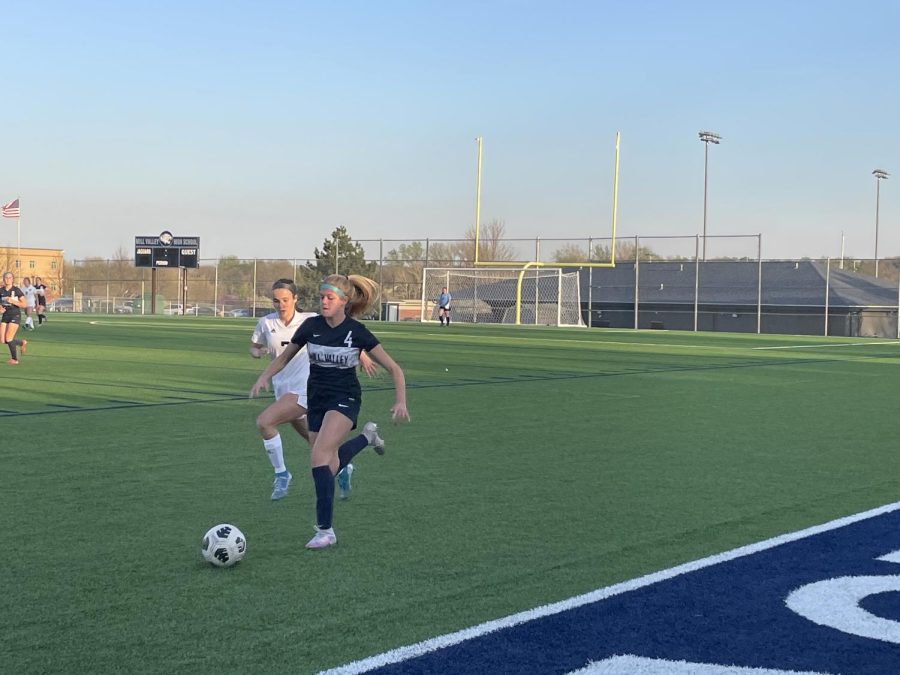 Trying to avoid the opponent player behind her, sophomore Brooke Bellehumeur kept running with her possession of the ball