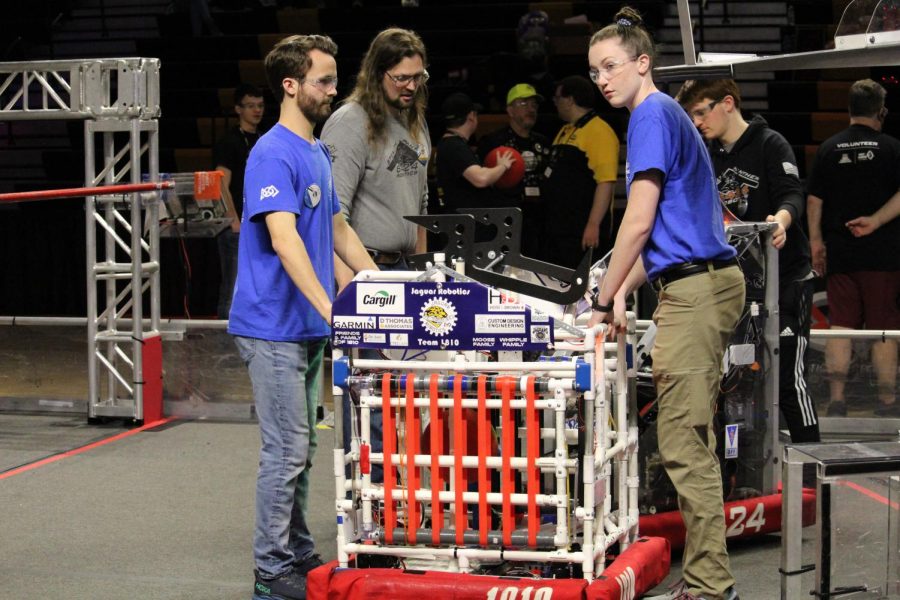 Seniors Ryan Layton and Maddie Vosburg move the teams robot, Drilbur, onto the field for a qualification match. The team ranked 15th overall at the regional and made it to the semifinals Friday, April 1