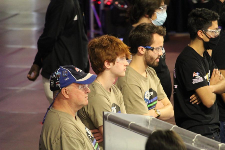 Seniors Ryan Layton and Darren Hall and mentor Mike Moose stand behind the drivers station as they wait for the match to begin Saturday, April 2