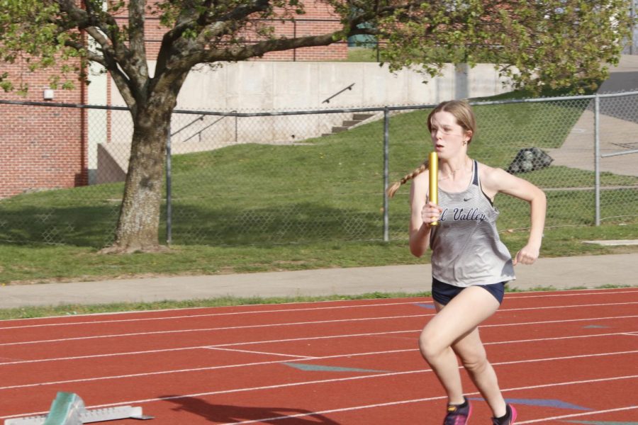 Baton in hand, freshman Addison Long kicks off the 4x100 meter relay. Long, along with freshman Josie Benson, sophomore Makenna Payne and junior Savannah Harvey, landed third place in the relay with a final 400 meter time of 52.62 seconds.